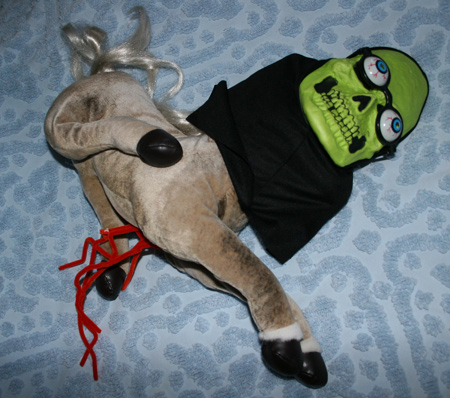 Disemboweled pony with skeleton mask and bug eye glasses. How cute!