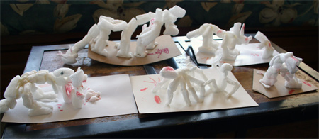 Our latest cornstarch packing poeanut  creations. Going from left to right: Two legged dinosaur eating man, big six legged creature, triceritops gouging man, somehting else, and gian tarantula attacking man